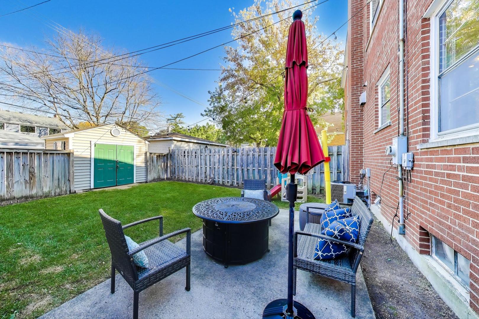 3131 Central Street Evanston, IL 60201 - Photo 24 of 28 a view of a backyard with furniture and a grill