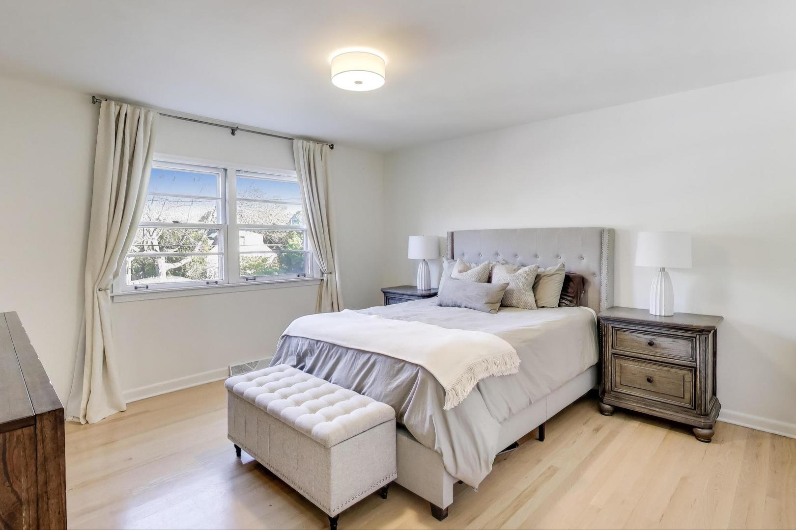 3131 Central Street Evanston, IL 60201 - Photo 10 of 28 a bedroom with a bed lamp and a window