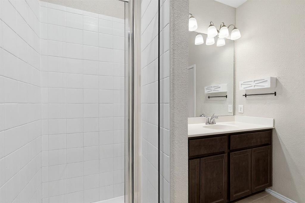 22038 Pheasant Bend Lane Porter, TX 77365 - Photo 15 of 25 a bathroom with a sink and a mirror