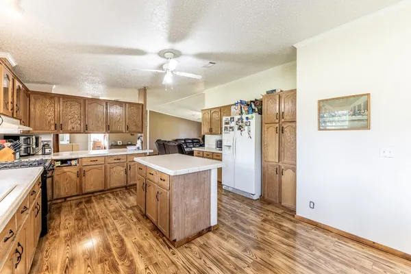 a kitchen with cabinets and wooden floor