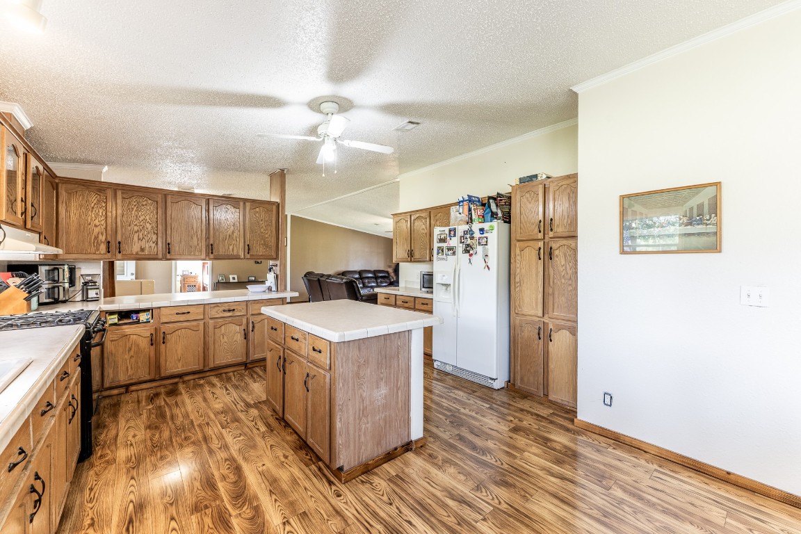 34 Harding Road Huntsville, TX 77340 - Photo 12 of 28 a kitchen with cabinets and wooden floor