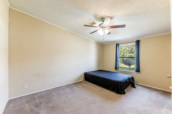 a living room with a bed and a window
