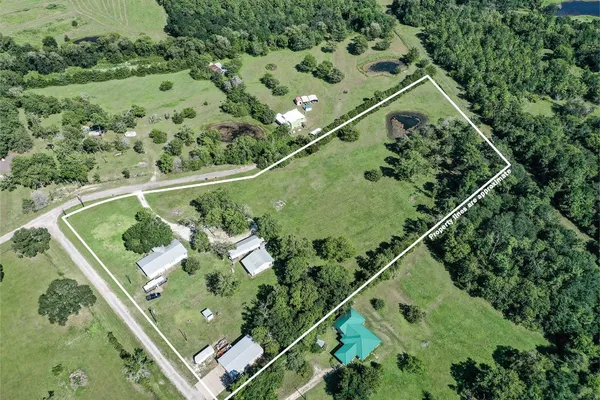 an aerial view of a residential houses with outdoor space