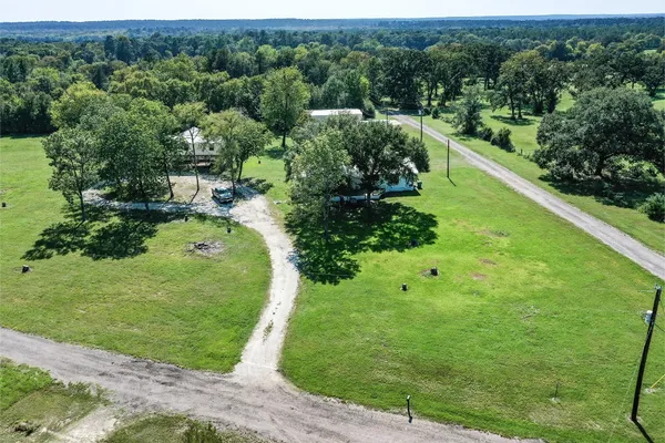 a view of a garden with a building in the background