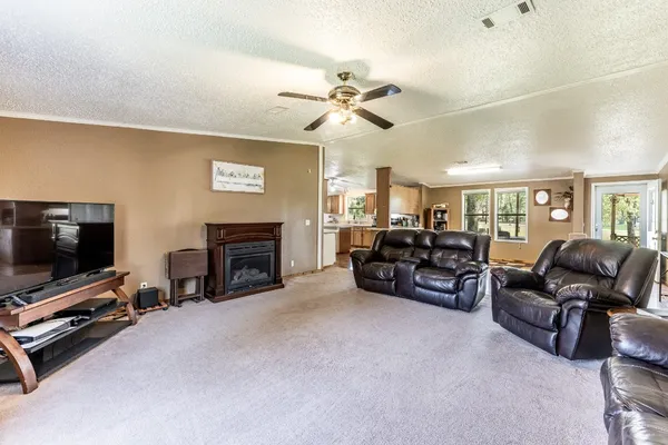 a living room with furniture gym equipment and a flat screen tv