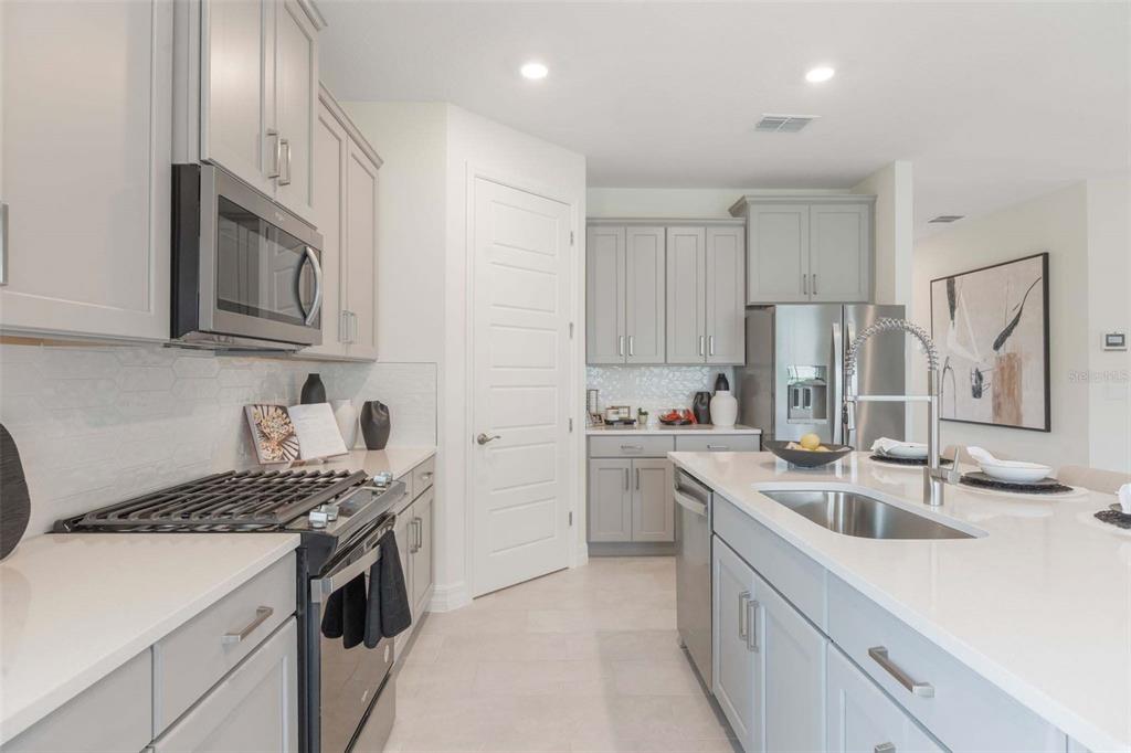 3952 Kennebunk Loop Mount Dora, FL 32757 - Photo 14 of 36 a kitchen that has a sink and a stove