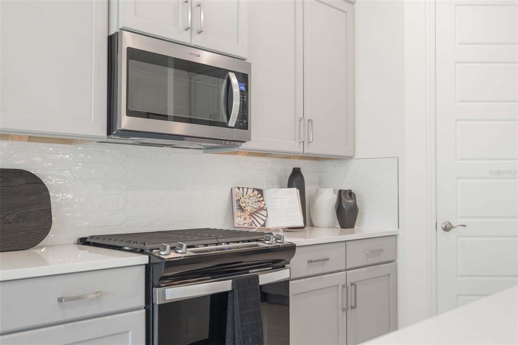 3952 Kennebunk Loop Mount Dora, FL 32757 - Photo 18 of 36 a kitchen with a stove and a microwave