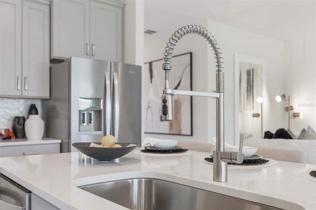 3952 Kennebunk Loop Mount Dora, FL 32757 - Photo 19 of 36 a kitchen with a faucet a sink and a refrigerator