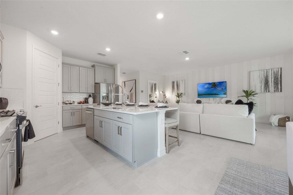 3952 Kennebunk Loop Mount Dora, FL 32757 - Photo 20 of 36 a kitchen with white cabinets and white appliances