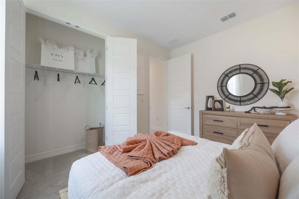 3952 Kennebunk Loop Mount Dora, FL 32757 - Photo 33 of 36 a bedroom with a bed and cabinets