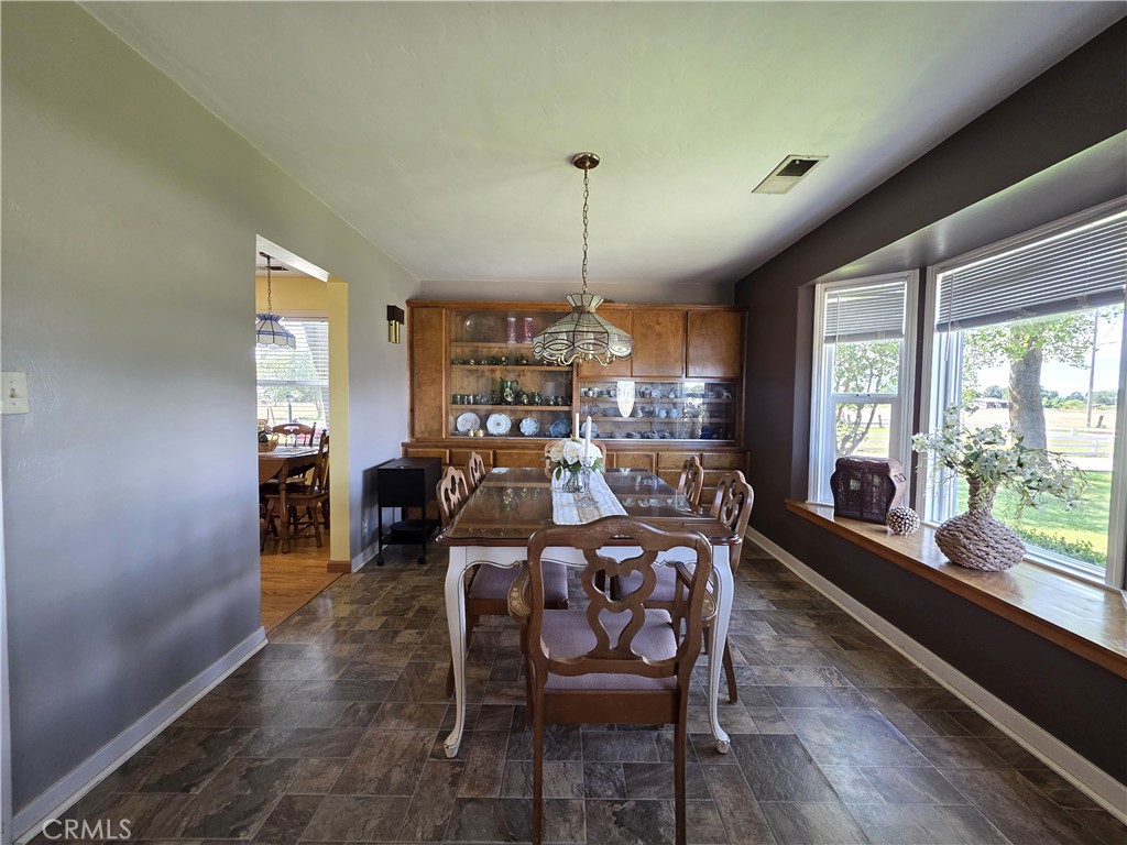 23773 River Road Corning, CA 96021 - Photo 12 of 64 a view of a dining room with furniture window and wooden floor