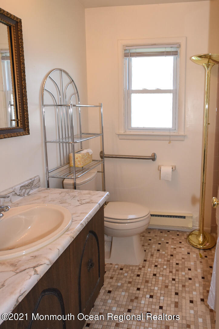 10 Lamb Road Brick, NJ 08724 - Photo 14 of 18 a bathroom with a sink a toilet and a mirror