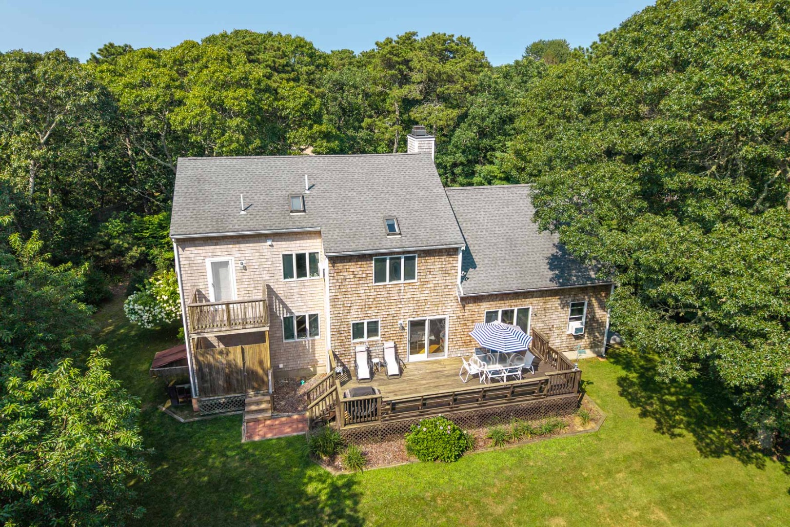 12 Duarte Circle Edgartown, MA 02539 - Photo 4 of 43 an aerial view of a house with a yard table and chairs