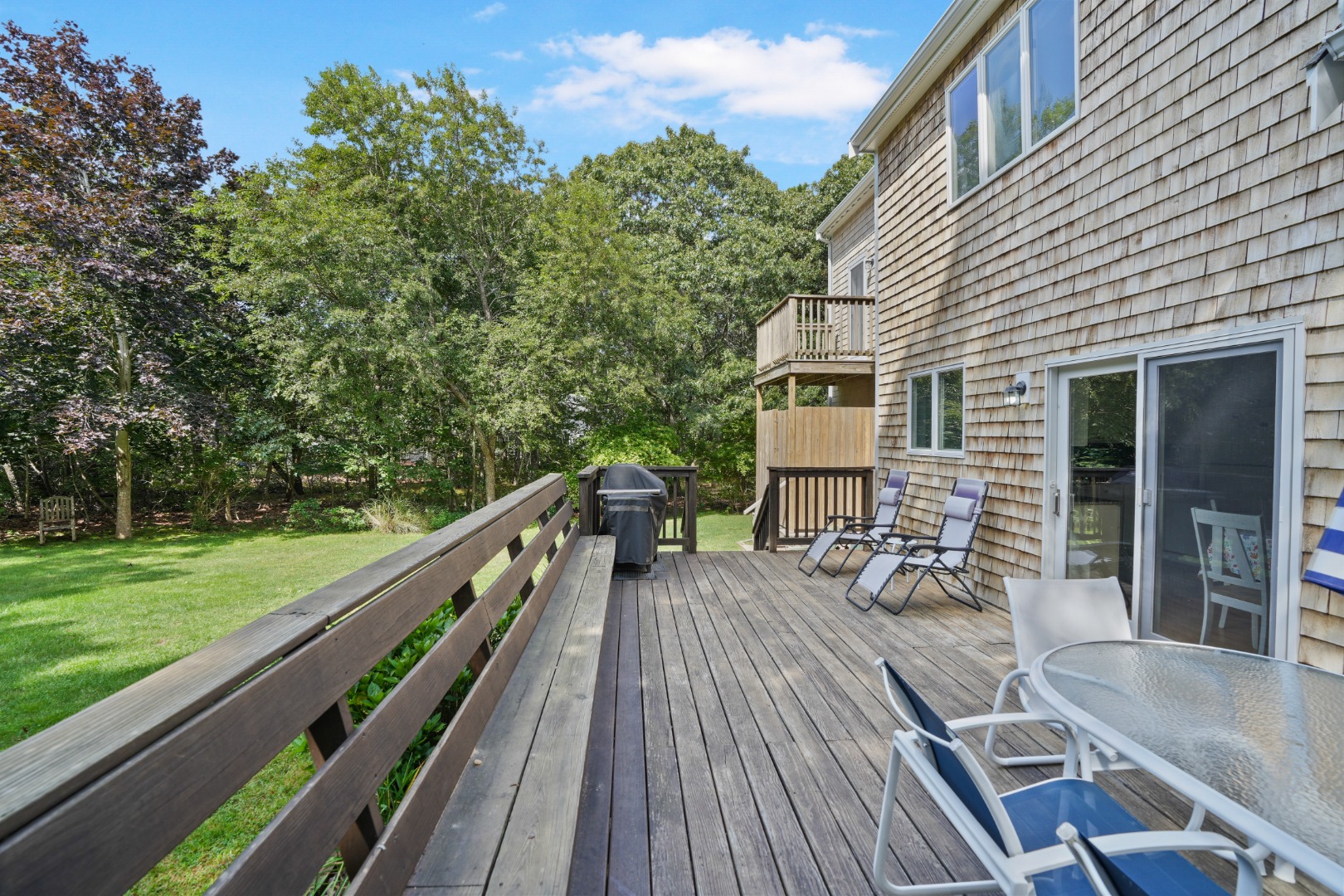 12 Duarte Circle Edgartown, MA 02539 - Photo 43 of 43 a balcony with wooden floor table and chairs