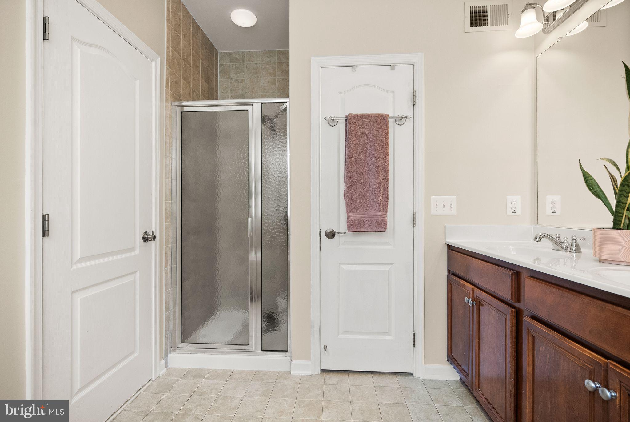 12414 A Liberty Bridge Road Fairfax, VA 22033 - Photo 23 of 38 a bathroom with a shower sink and mirror