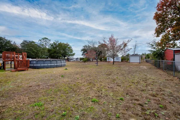 a view of outdoor space with deck and yard