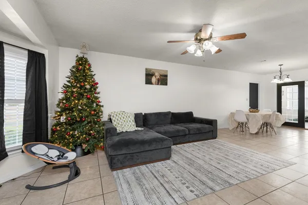 a living room with furniture and a christmas tree