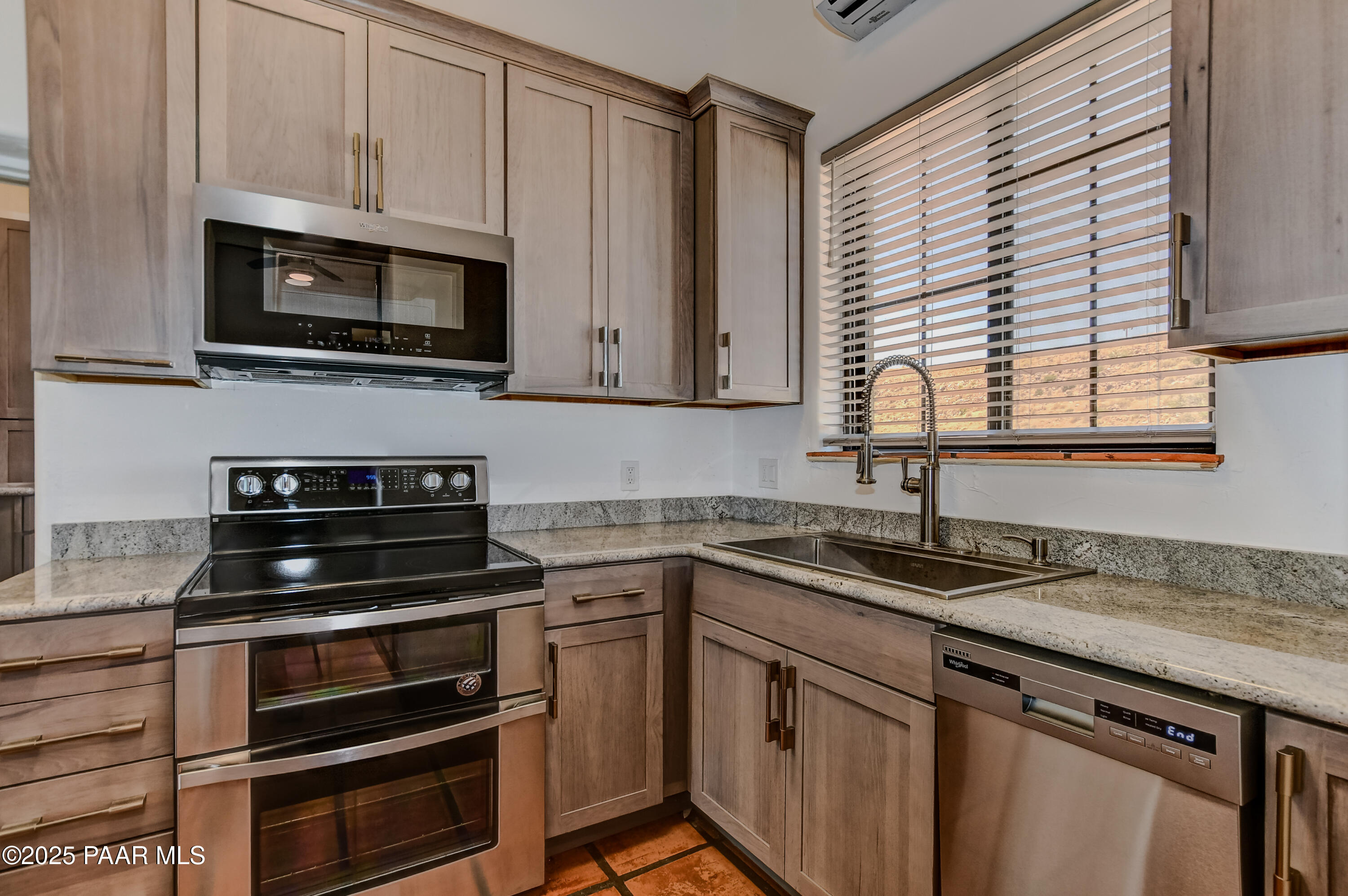 3200 West Rugged Spirit Trail Prescott, AZ 86305 - Photo 16 of 48 a kitchen with granite countertop a sink cabinets and stainless steel appliances