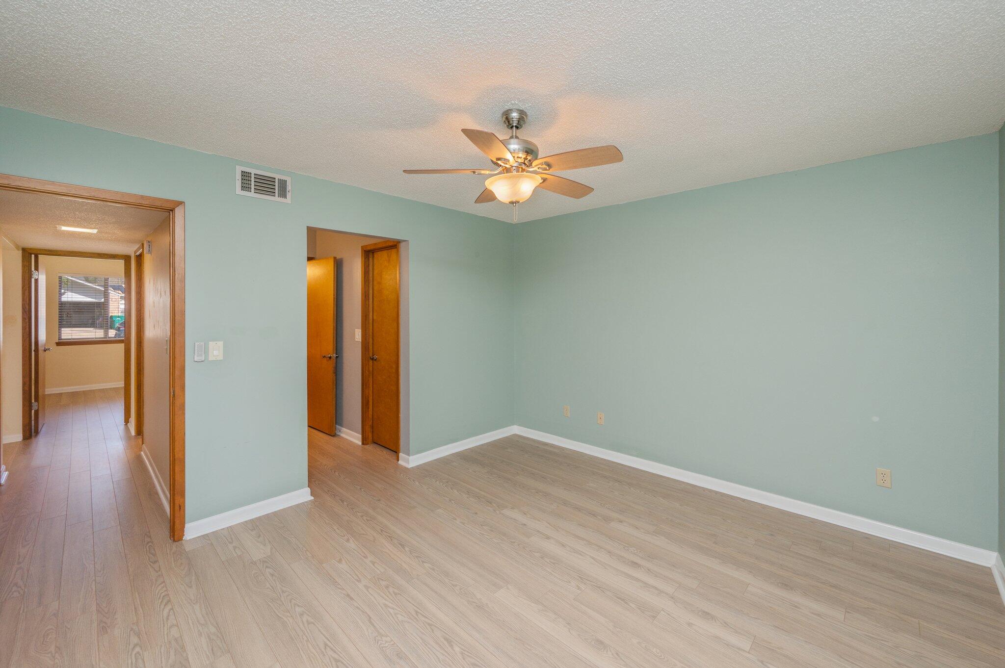 101 Cedar Ridge Way Niceville, FL 32578 - Photo 17 of 33 wooden floor in an empty room with a window