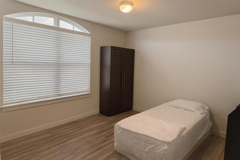 5641 Durst Lane Forney, TX 75126 - Photo 5 of 10 Bedroom featuring wood finished floors and baseboards