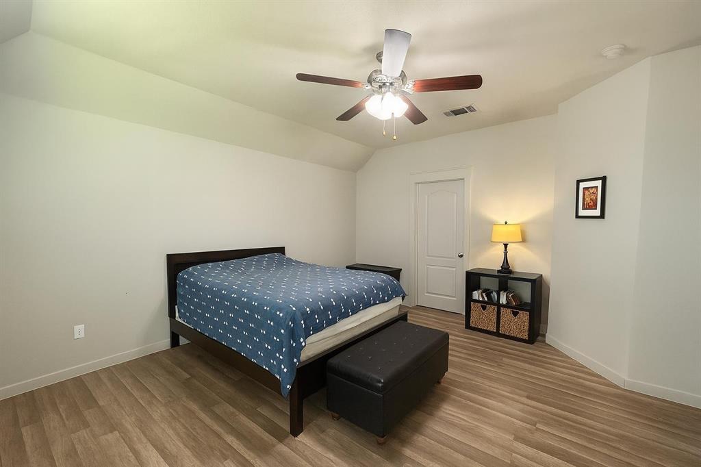 5641 Durst Lane Forney, TX 75126 - Photo 9 of 10 Bedroom featuring lofted ceiling, wood finished floors, and a ceiling fan
