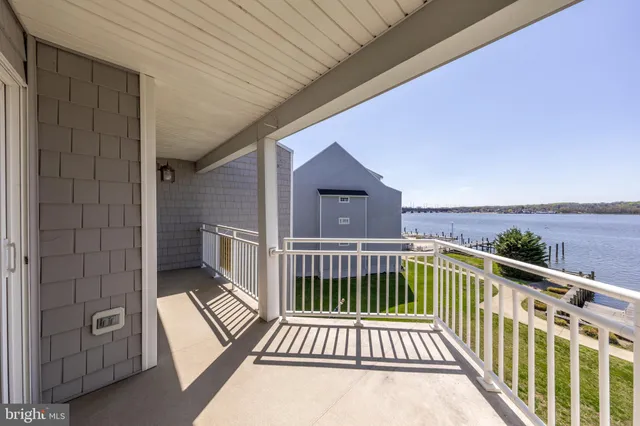 a spacious bedroom with a bed a couch and a large window