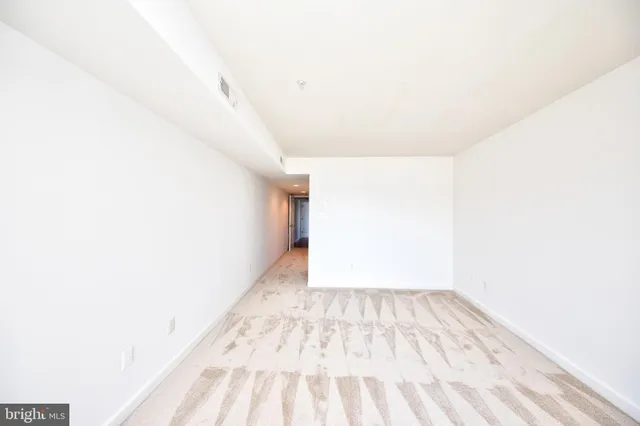 a view of a lake with a mountain and a table under an umbrella