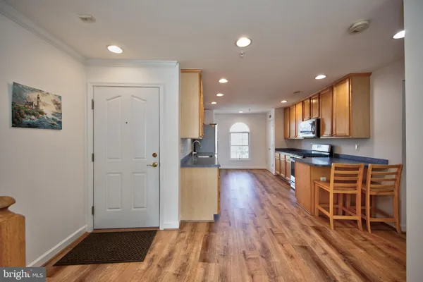 a view of a hallway with wooden floor and furniture
