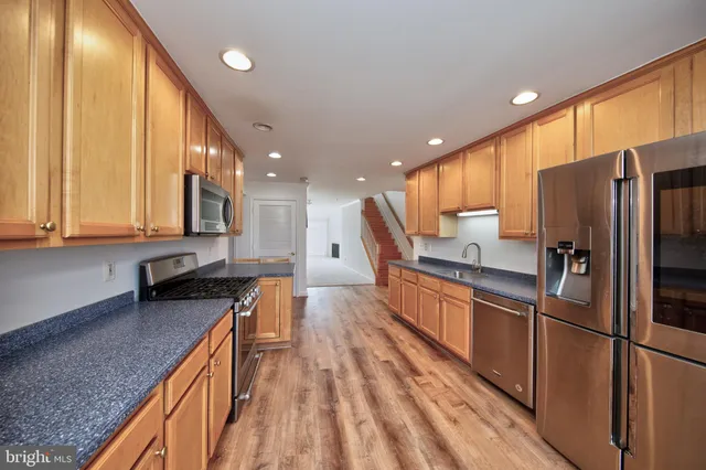 a view of a hallway with wooden floor
