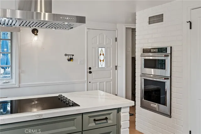 a kitchen with a sink stove and refrigerator