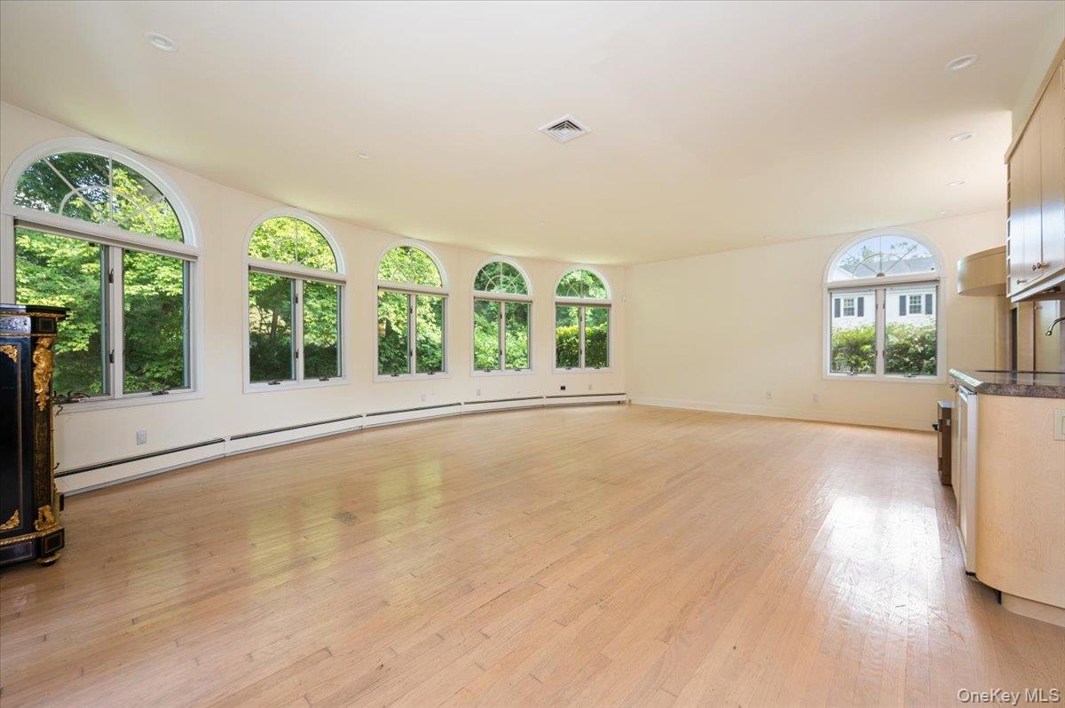 1 Parkside Drive Great Neck, NY 11021 - Photo 4 of 30 Unfurnished living room featuring baseboard heating and light wood finished floors