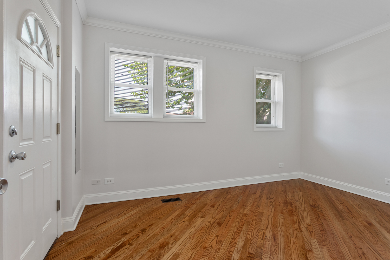 4110 North Keystone Avenue, Unit 1N Chicago, IL 60641 - Photo 11 of 15 a view of an empty room with wooden floor and a window