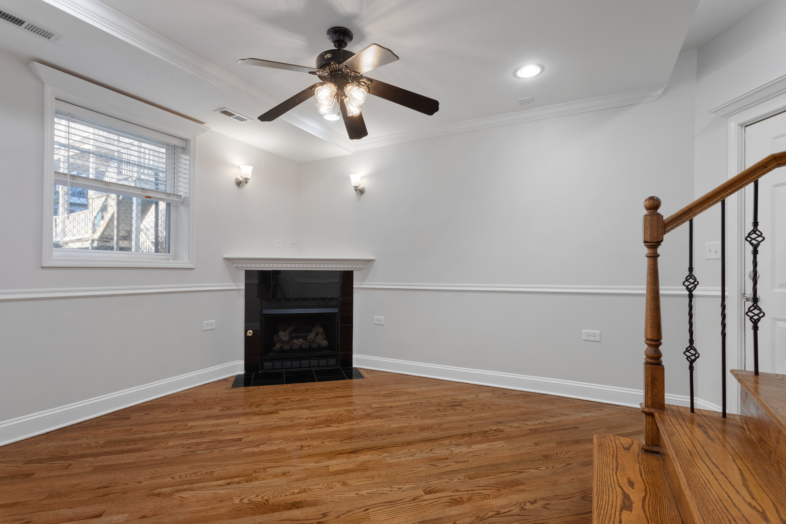4110 North Keystone Avenue, Unit 1N Chicago, IL 60641 - Photo 3 of 15 an empty room with wooden floor fan and windows
