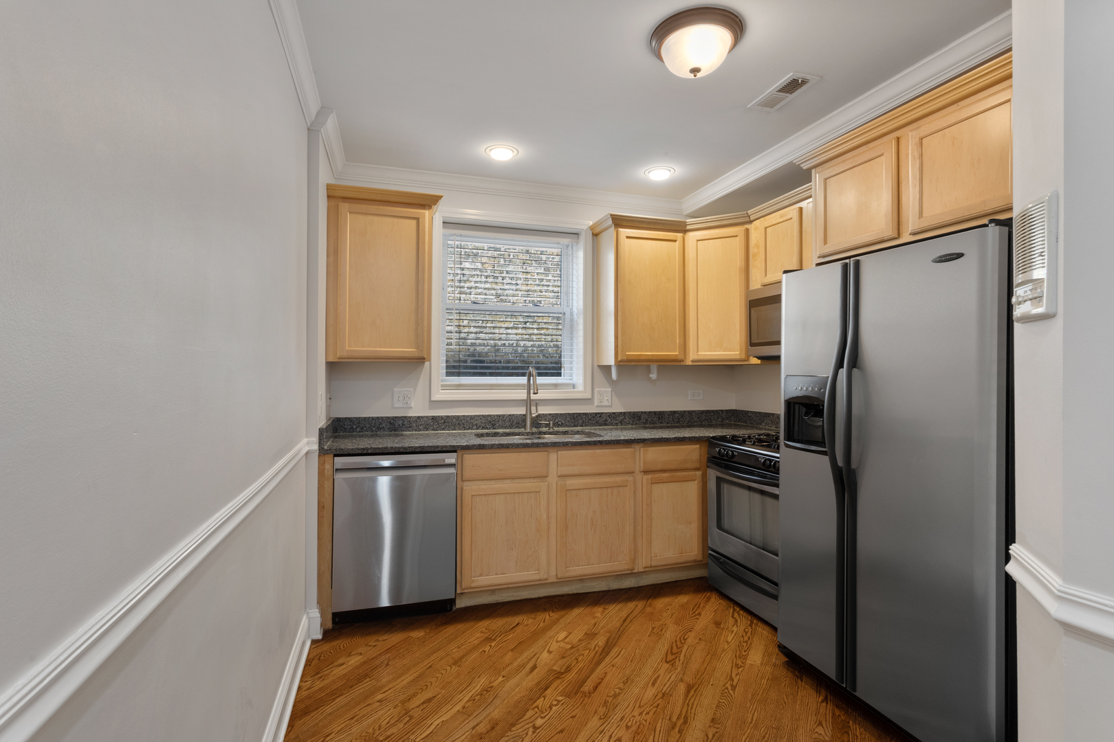 4110 North Keystone Avenue, Unit 1N Chicago, IL 60641 - Photo 4 of 15 a kitchen with stainless steel appliances granite countertop a refrigerator a sink a stove and island