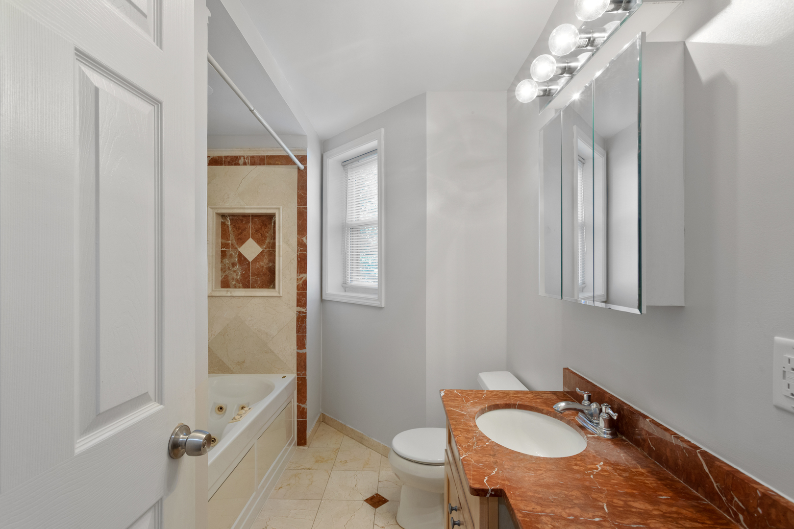 4110 North Keystone Avenue, Unit 1N Chicago, IL 60641 - Photo 6 of 15 a bathroom with a granite countertop sink toilet and shower