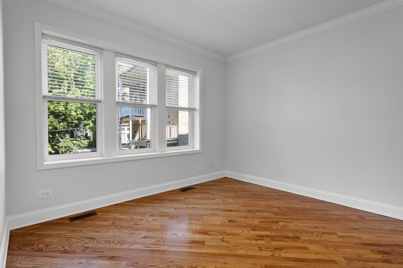 4110 North Keystone Avenue, Unit 1N Chicago, IL 60641 - Photo 9 of 15 a view of empty room with wooden floor and fan