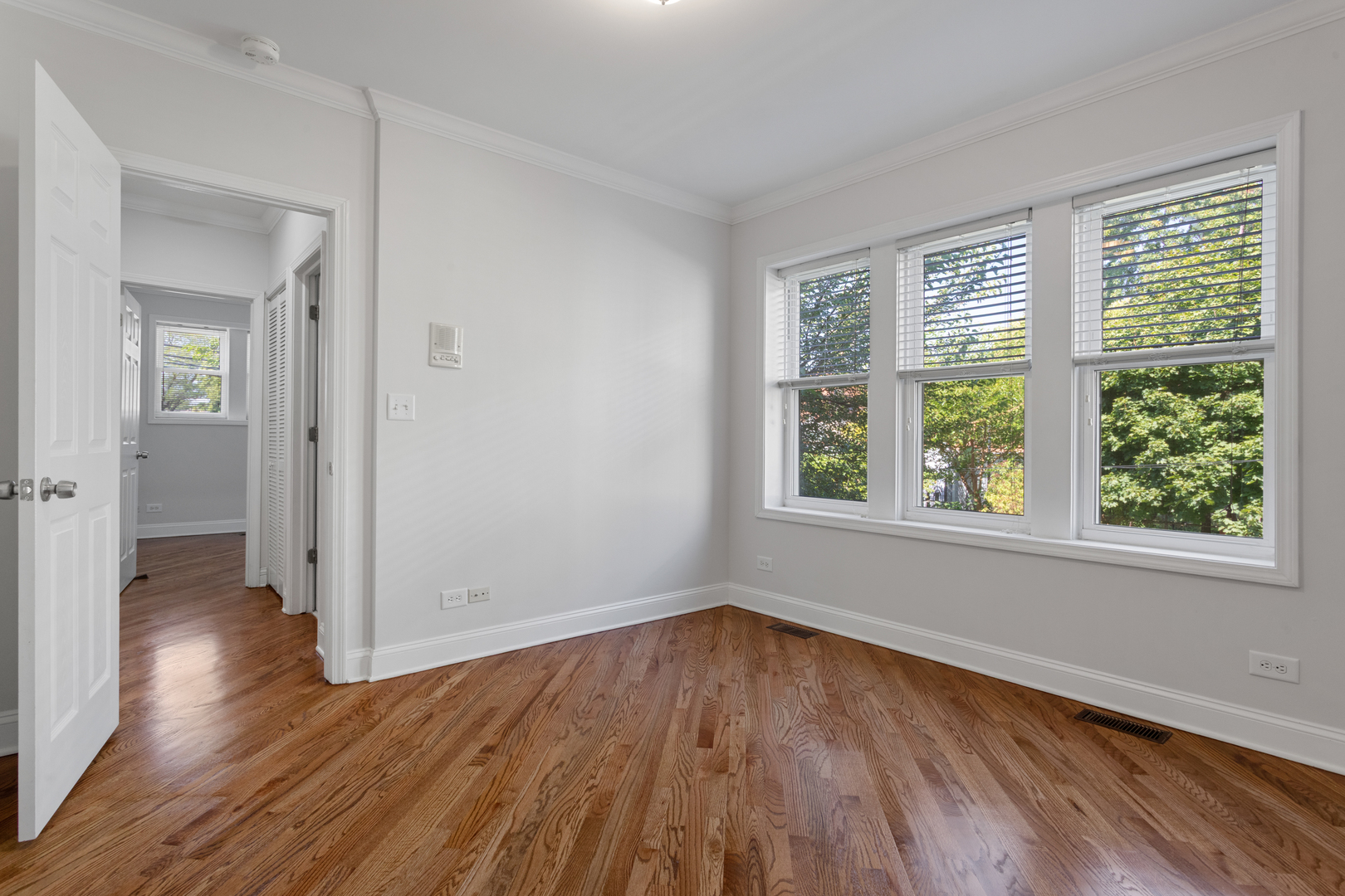 4110 North Keystone Avenue, Unit 1N Chicago, IL 60641 - Photo 10 of 15 wooden floor in an empty room with a window
