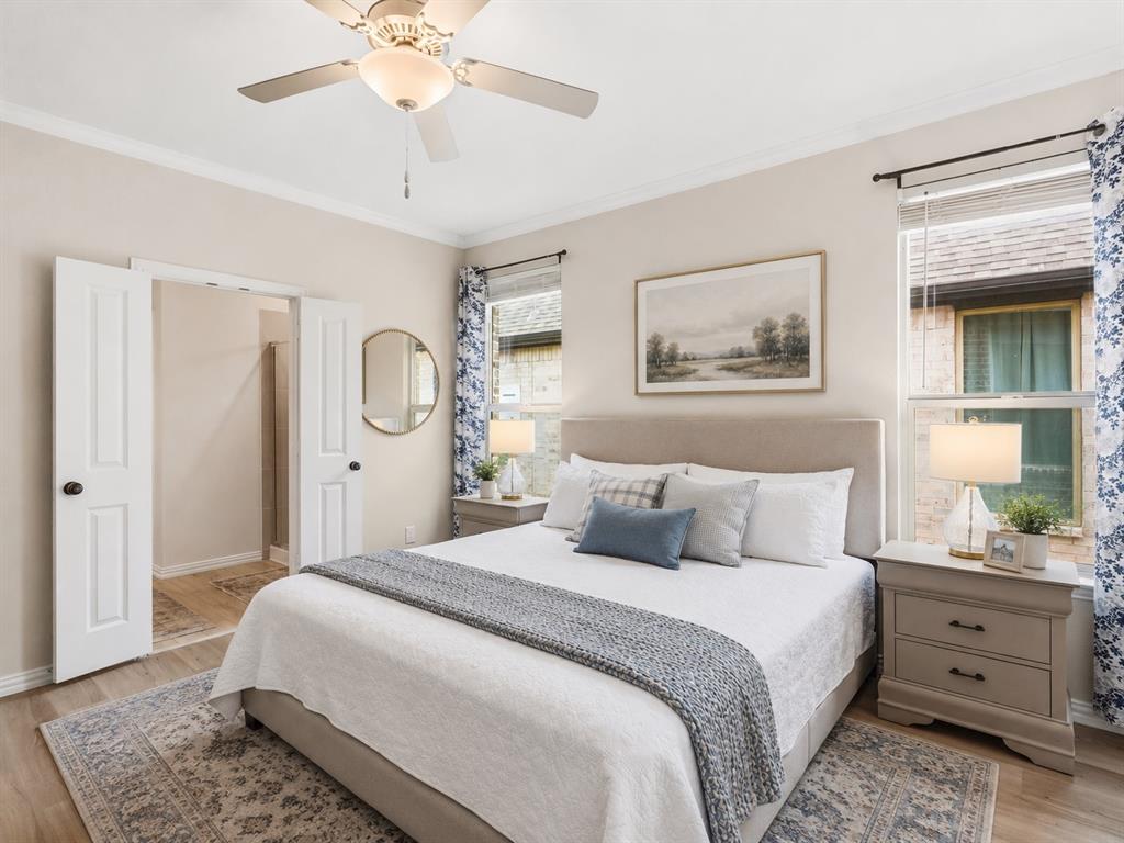 16936 Post Cedar Drive Justin, TX 76247 - Photo 11 of 30 Bedroom featuring crown molding, wood-finish flooring, two large windows, and a ceiling fan with light fixture
