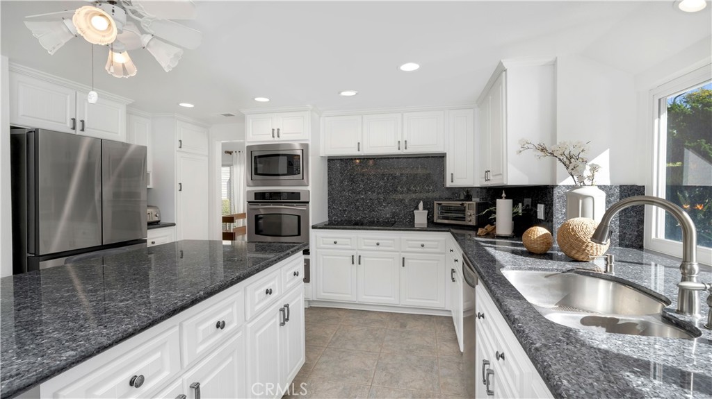 7 Nantucket Irvine, CA 92620 - Photo 15 of 55 a large kitchen with granite countertop a large counter top stainless steel appliances and cabinets