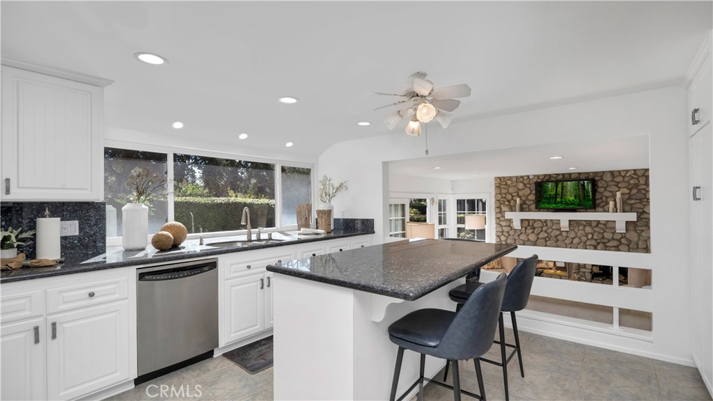 7 Nantucket Irvine, CA 92620 - Photo 17 of 55 a kitchen with a dining table chairs and refrigerator