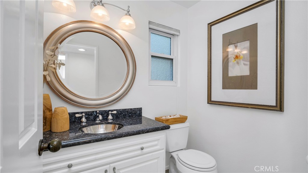 7 Nantucket Irvine, CA 92620 - Photo 28 of 55 a bathroom with a toilet a sink and a mirror