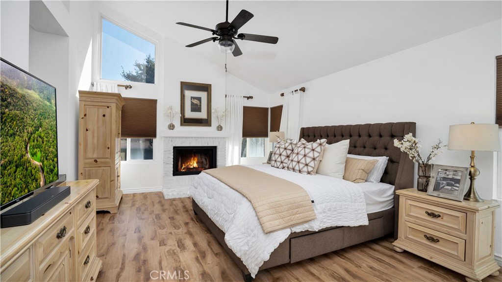 7 Nantucket Irvine, CA 92620 - Photo 37 of 55 a bedroom with a large bed and a fireplace