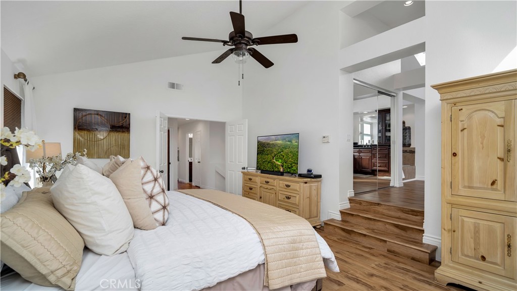 7 Nantucket Irvine, CA 92620 - Photo 39 of 55 a bedroom with a bed a flat screen tv and a dresser