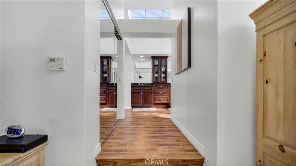 7 Nantucket Irvine, CA 92620 - Photo 41 of 55 a hallway with wooden floor windows and livingroom
