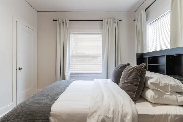 a bedroom with a bed and a window