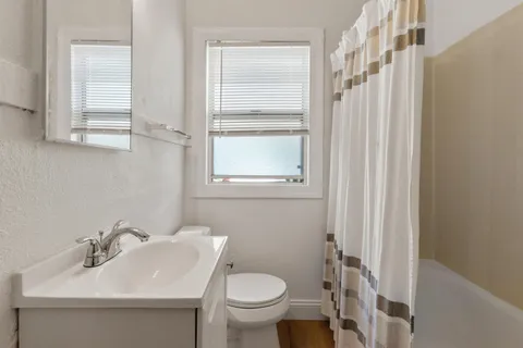 a bathroom with a sink toilet and vanity