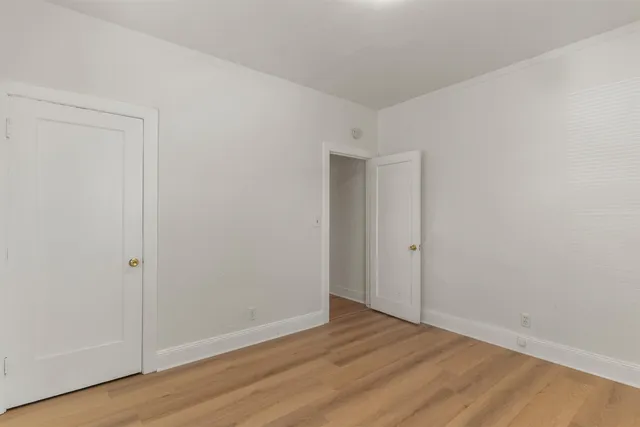 a view of an empty room and wooden floor
