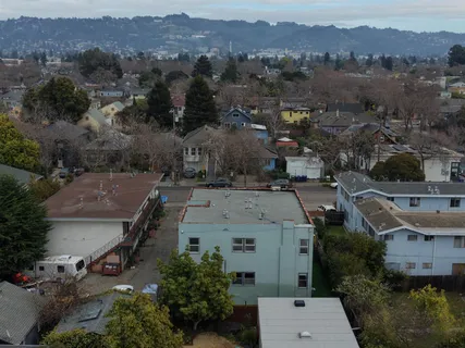 an aerial view of a house with a city view