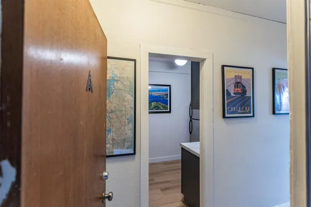 a view of a hallway with paintings on the wall