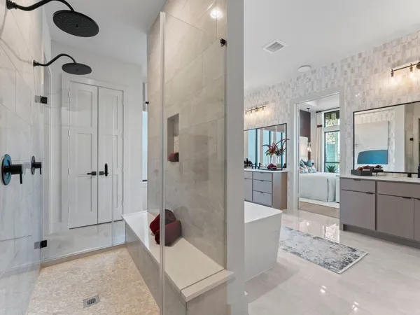 a bathroom with a tub sink and mirror